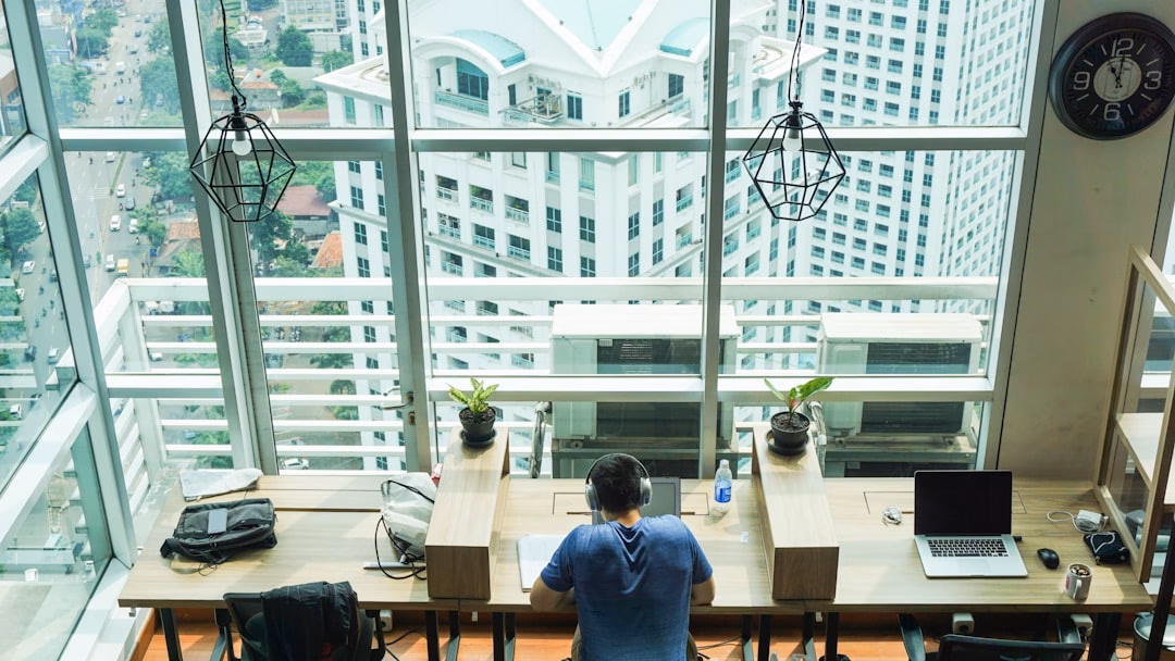 best business travel destinations — entrepreneurs working at desks in modern Asian office tower