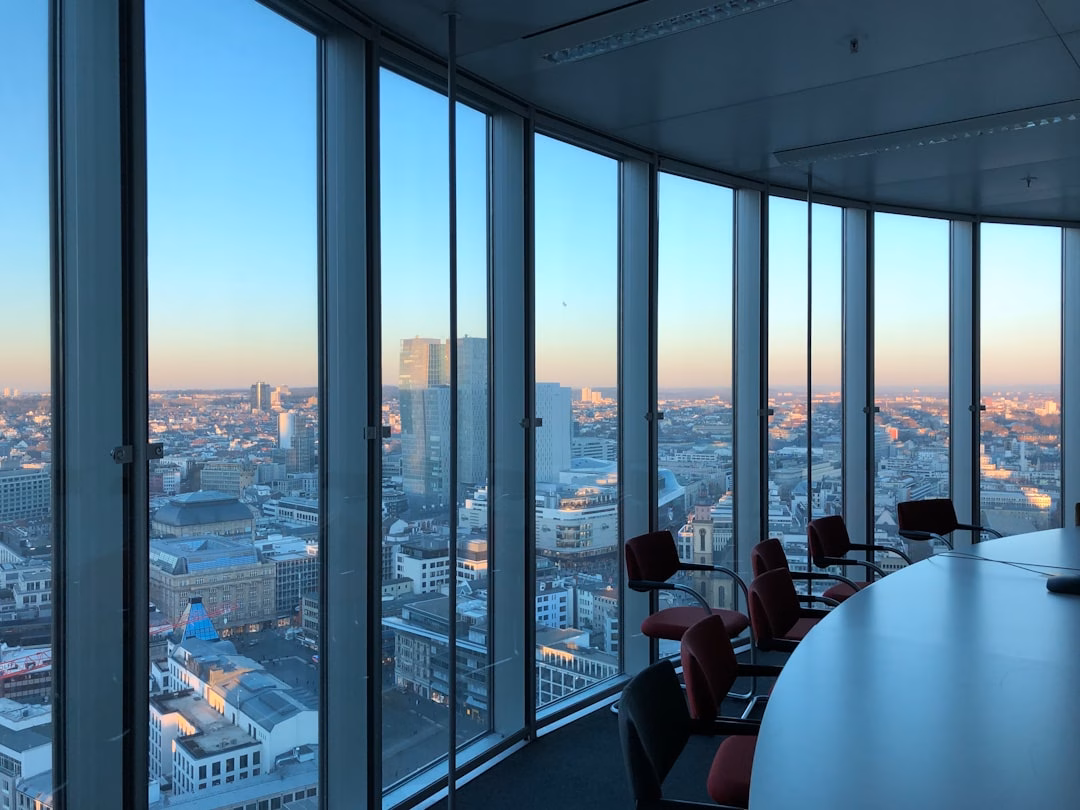 best business travel destinations — conference room overlooking skyline with people in meeting