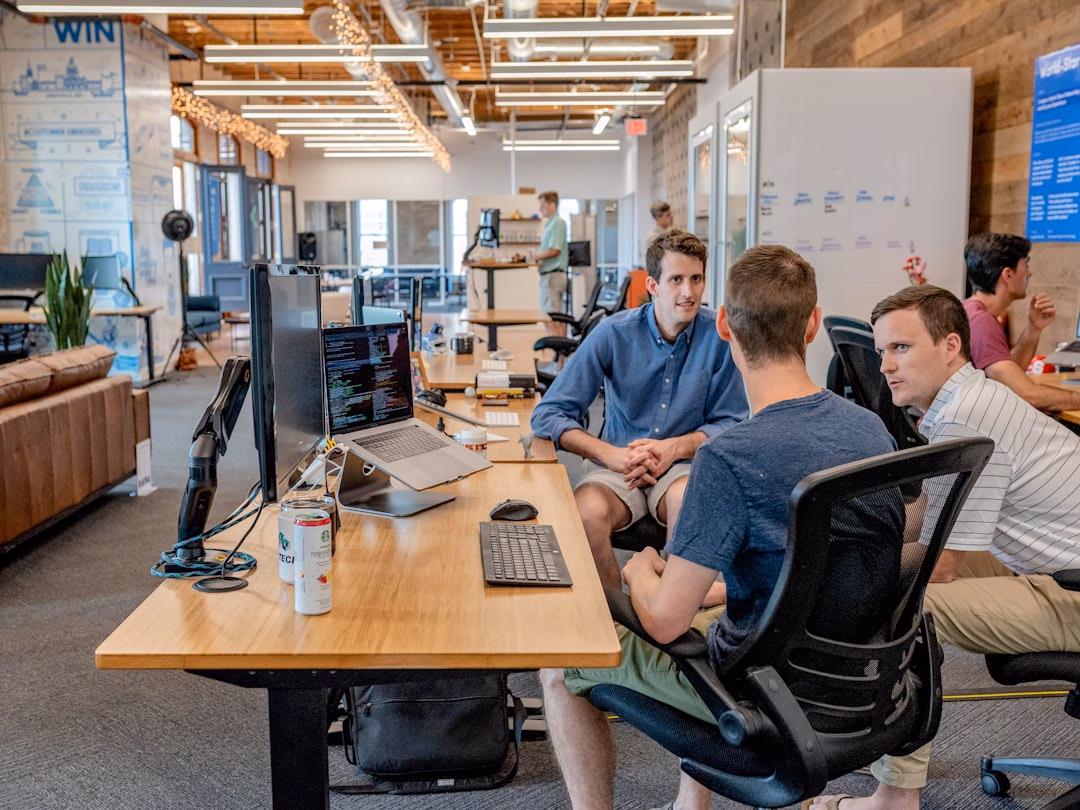 predictive finance way companies — team collaborating on cash flow forecast with charts and reports visible on computer monitors