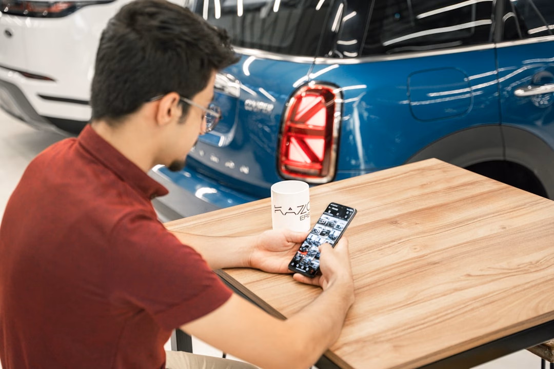 battery-swapping technology reshape electric — worker at NIO swap station viewing battery exchange on tablet