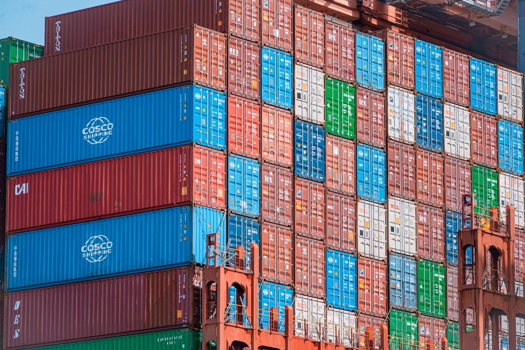 trade credit supports cash — global shipping containers stacked at a port terminal