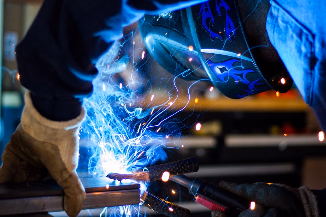 apprenticeship programs students employers — apprentice learning hands-on welding skills in industrial workshop